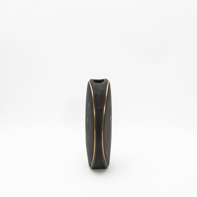 The elegant Oval Vase by R&Y Augousti, crafted in shagreen and accented with brass, is a sophisticated fusion of organic...