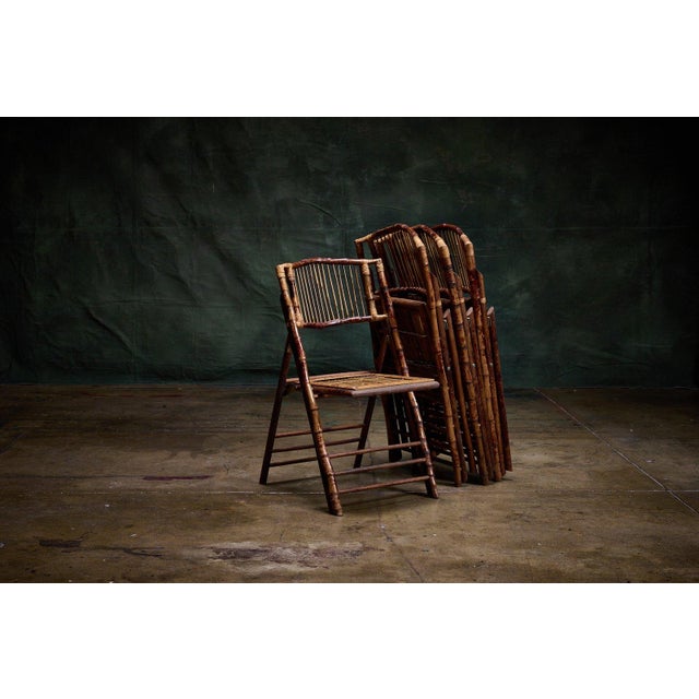 Vintage set of four burnt tortoiseshell bamboo folding chairs with slatted backs and slatted seats. - Set of four matching...