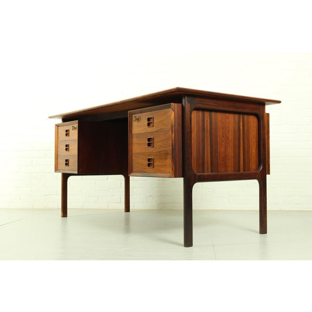 Stunning desk in rosewood, Denmark 1960s.The desk has two pedestals on the front, each containing 3 drawers and 3 niches...