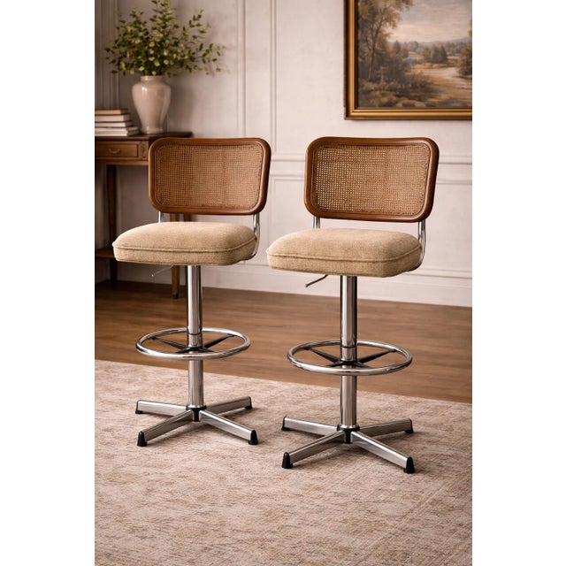 This set of four cane-back upholstered barstools dates to the late 1960s–1970s and exemplifies relaxed American...