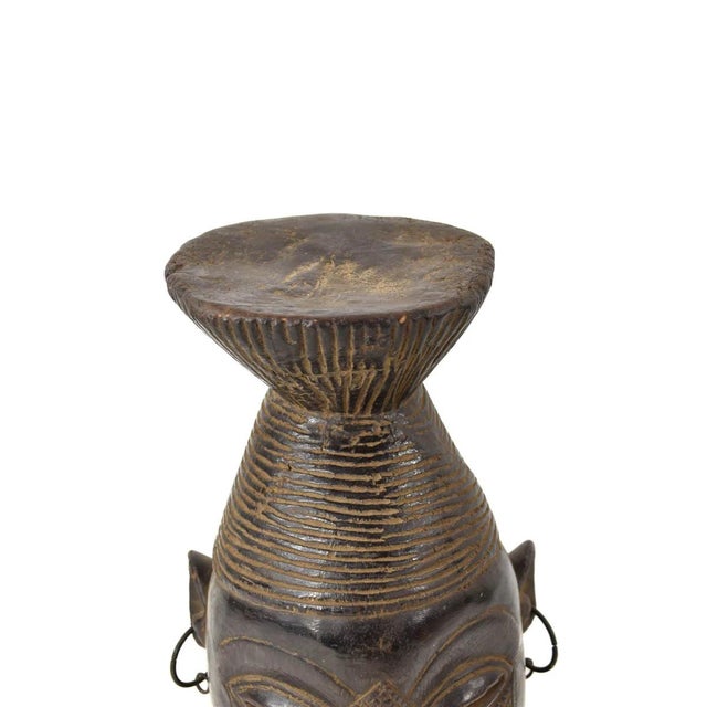 This Mangbetu Helmet Mask from Congo features a unique conical design, geometric facial patterning, narrow eyes, and metal...