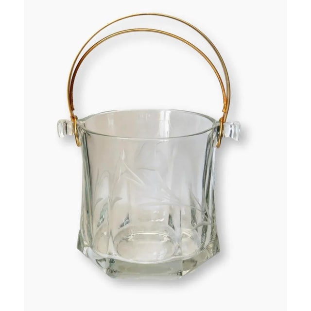 Medium sized crystal etched ice bucket with brass handle. Bottom of the ice bucket engraved "Italy".