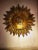 Authentic vintage gilded wrought iron lamp, manufactured in Europe between the 1950s and 1960s. Its sculptural sunburst...