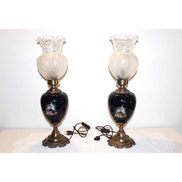 An elegant pair of buffet lamps made in Europe in the 1950s–60s. The glossy cobalt blue ceramic bases are hand-decorated...