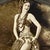 This striking and evocative antique sepia tone photograph, features a posed female hula dancer in traditional costume with...