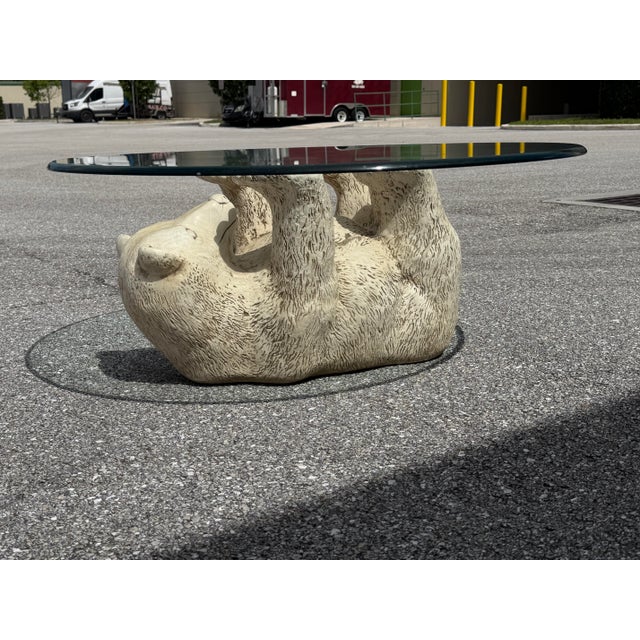 A Stylish midcentury Ceramic Polar Bear with round Glass Top Coffee Table, circa 1970s. The bear base is in great...