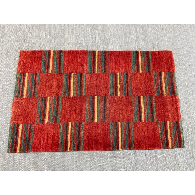 Design Plus Gallery presents a 2ft × 3ft 2in Handwoven Flatweave Patchwork Kilim Area Rug. The rug has a distinctive block...