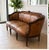 Beautiful vintage leather sofa with an elegant carved wood frame and classic French-inspired design. This is a statement...