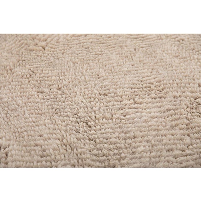 Elegant hand-knotted wool rug in Light Taupe and Ivory, featuring a subtle herringbone texture. The delicate interplay of...