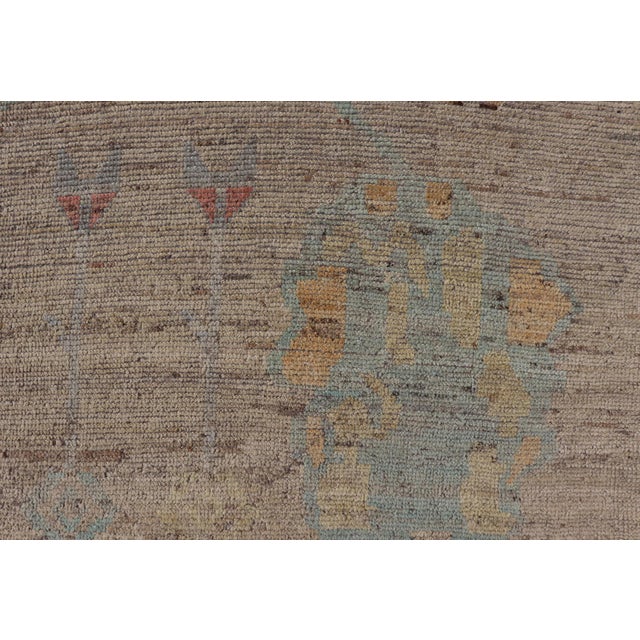 Measures: 8'7 x 9'7. This modern casual tribal rug has been hand-knotted in wool. The rug features a modern sub-geometric...