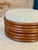 A beautifully sculptural vintage bent rattan ottoman featuring a stacked, layered design that gives it that bold,...