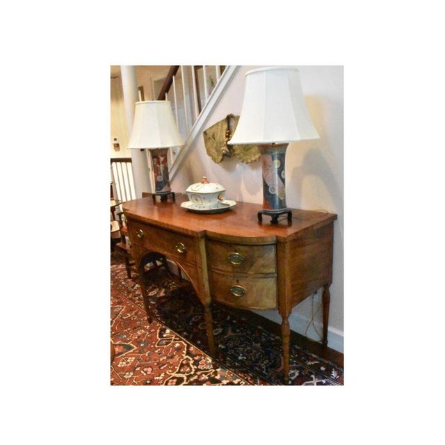 English Sheraton sideboard with a shaped top having arcaded corners , circa 1785. Perfectly organize the dining room...