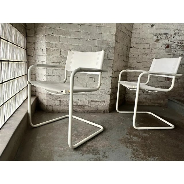 Pair of 1980s Italian cantilever chairs attributed to Bauhaus designers Mart Stam and Marcel Breuer. The white tubular...