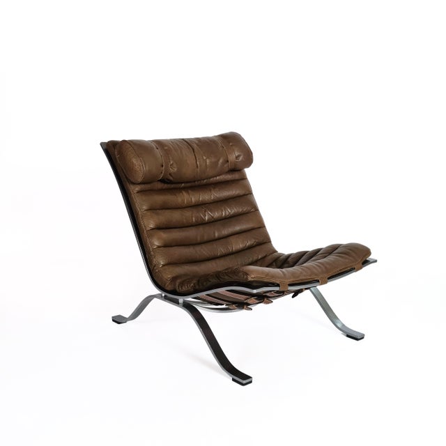 Ari lounge chair with a chrome steel frame, designed by Swedish designer Arne Norell in 1960. This vintage lounge chair &...