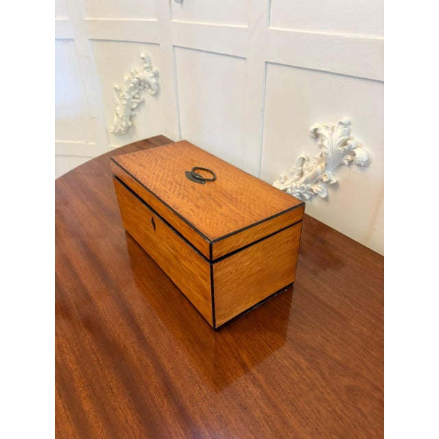 A fine and elegant Georgian satinwood tea caddy of exceptional colour and figuring dating to the late 18th century. A...
