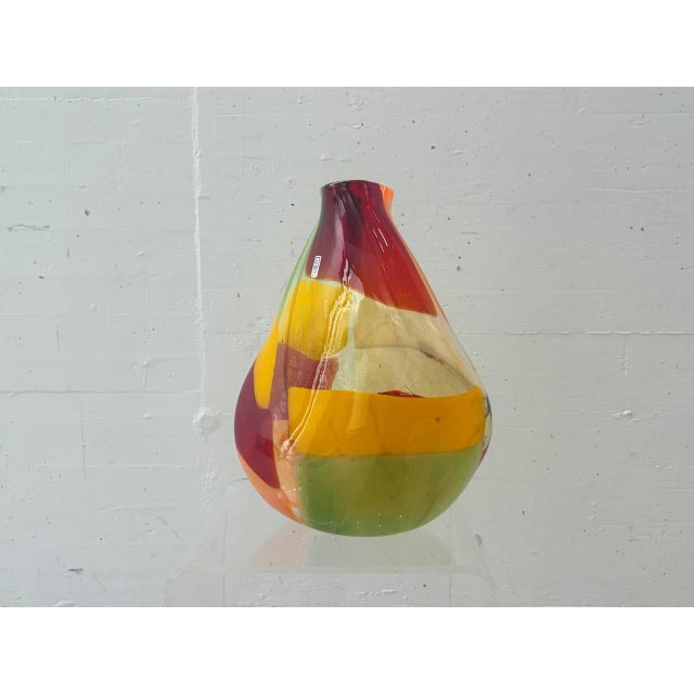 Expressive studio glass vase by Mdina Glass Malta with an organically shaped body and vibrant interplay of red, orange,...