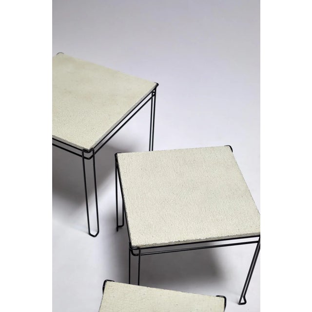 Set of (3) nesting tables with original black enameled wire metal frames and later-made plaster-crackle tops; Netherlands,...