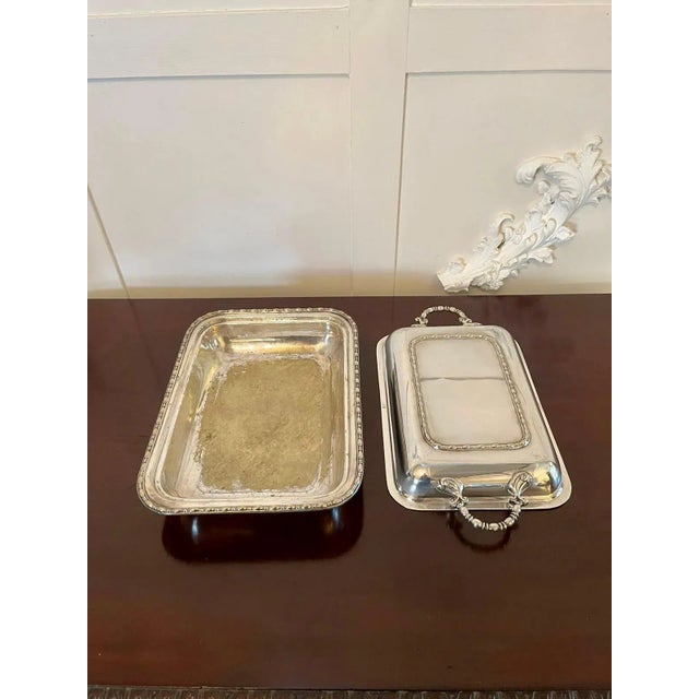 Antique silver plated entrée dish having a quality lift off top with twin handles above a silver plated dish with an...