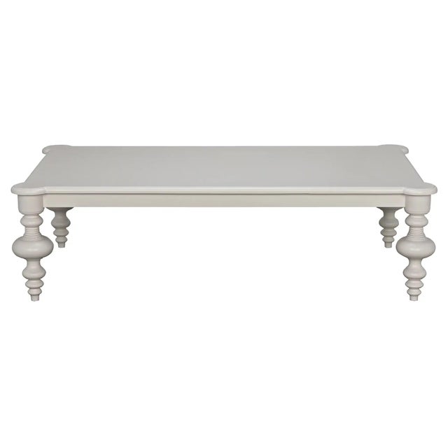 This sophisticatedly symmetrical coffee table features a rectangular mahogany top with rounded embellished corners that...