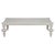 This sophisticatedly symmetrical coffee table features a rectangular mahogany top with rounded embellished corners that...