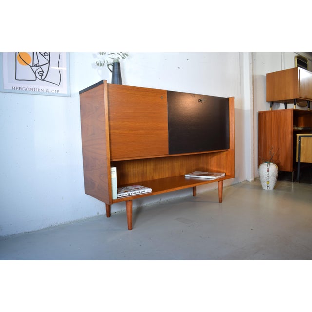 This teak sideboard was made in the 1960s by the German furniture manufacturer Sen Contal. The cabinet features newly...