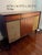 Refinished vintage stereo console featuring warm walnut-toned wood, original woven speaker fronts, and clean mid century...