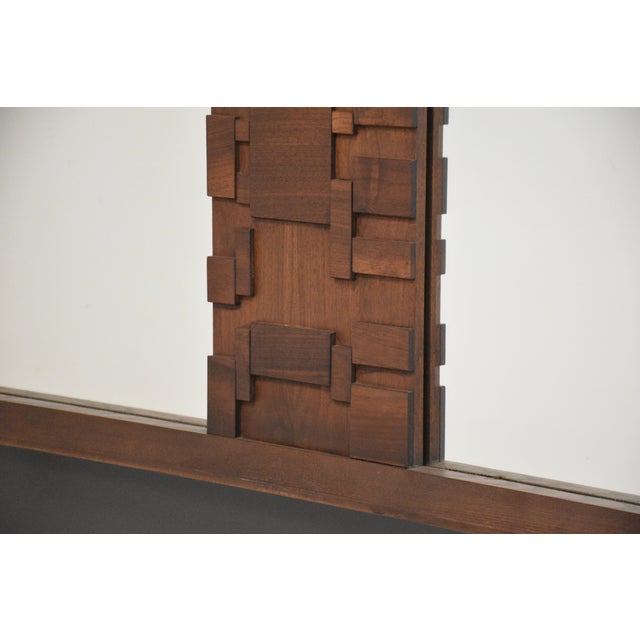 A mid century modern brutalist mirror. Made in Canada. Circa 1970’s. Excellent condition. 62.25” wide. 2” deep. 36.5” tall.