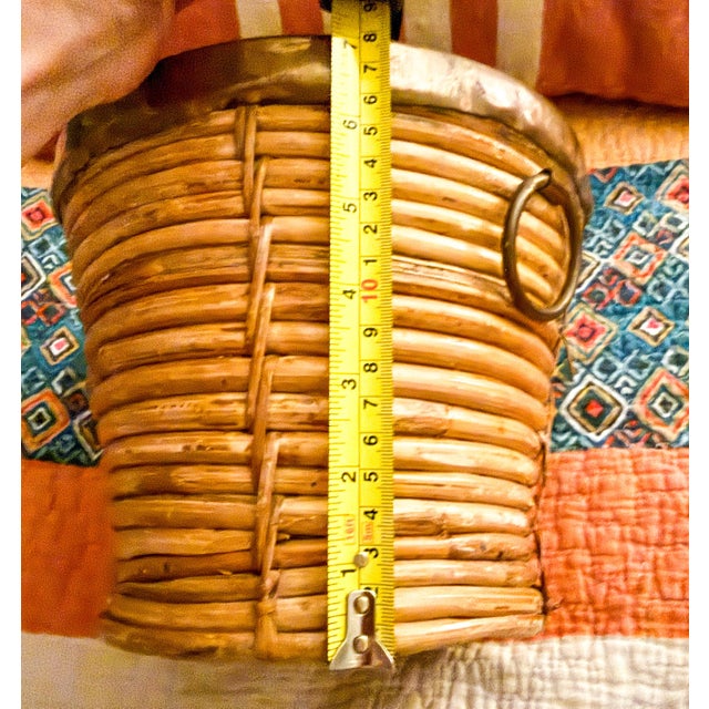 This is a mid-century modern Italian coiled rattan and brass basket with handles. Handcrafted in Italy, typically during...