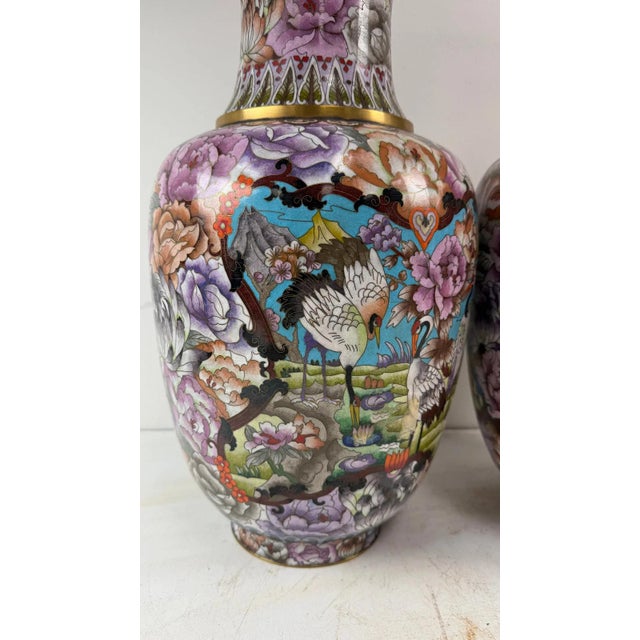 Pair of large cloisonne enamel vases richly decorated with cranes and floral motifs. Provenance: Beverly Hills Barakat...