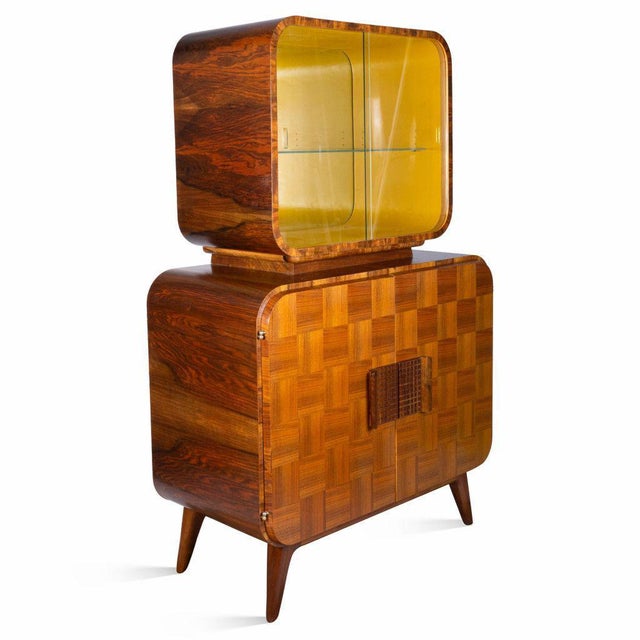 Wooden sideboard with an attached vitrine, also known as a "television", was designed in the 1940s by Jindřich Halabala...