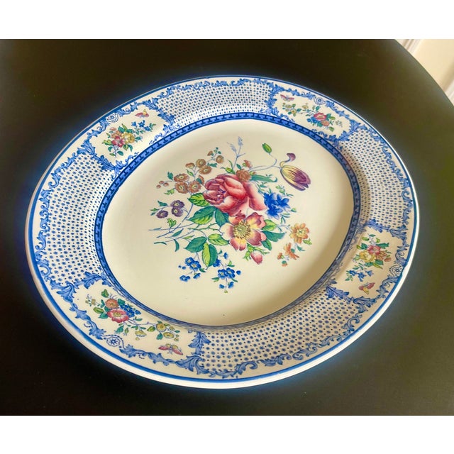 19th century floral ironstone platter by Cauldon. Central rose motif and blue and white transfer ware design on edge.