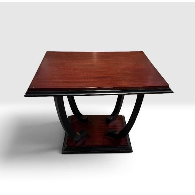 An Art Deco wooden side table featuring a stepped square top, curved supports, and a tiered base. Table can also be used...