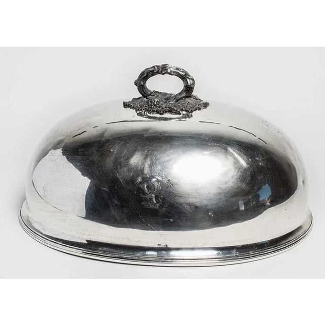 Elegant silver-plate dome dish cover with ornate handle, made in England in the 19th century.