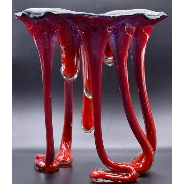 Extremely rare glass art piece made by Australian artist Peter Crisp in 1992. Signed by artist. Features red dangling legs...