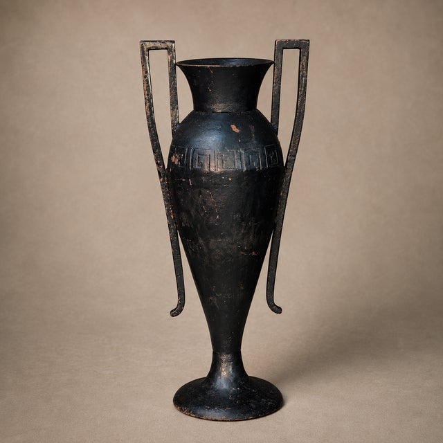 A striking 19th/20th-century black-enameled cast iron amphora urn, possibly American, with an elongated Neoclassical...