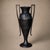A striking 19th/20th-century black-enameled cast iron amphora urn, possibly American, with an elongated Neoclassical...