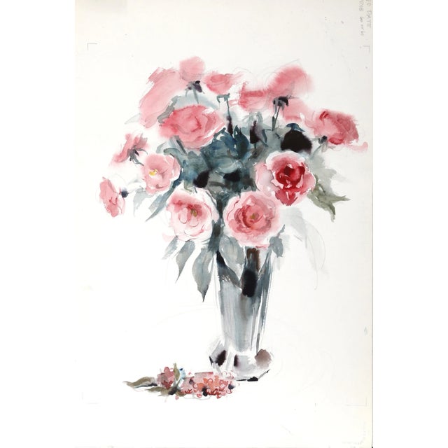 Arranged in a tall and narrow reflective vase, the bouquet of pink roses appears to burst out of its container in this...