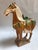 A striking mid-20th century Chinese ceramic horse modeled after the celebrated sancai-glazed horses of the Tang Dynasty....