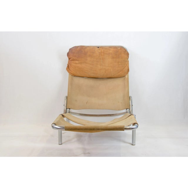This chaise lounge features upholstery in light brown suede.