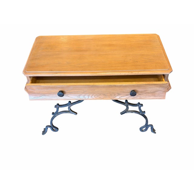 This elegant side table blends rustic charm with vintage industrial character, featuring a warm, natural wood top with...