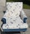 A distinctive upholstered armchair and matching ottoman by Hickory Chair, featuring rich blue velvet upholstery paired...
