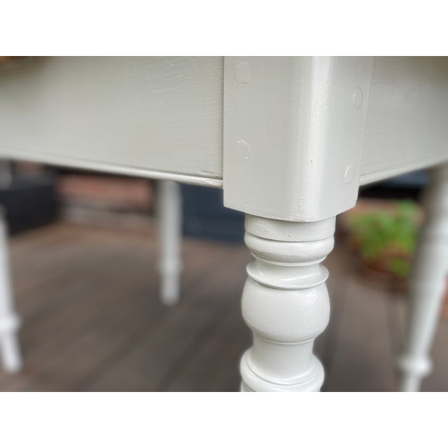 This charming antique extendable table has been given a fresh coat of paint by us; we sanded and oiled the surface. Width:...