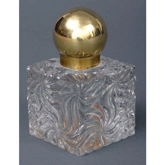 Large French glass inkwell in a swirl design with brass hinged ball-shaped cover. Not signed but very likely by Baccarat....
