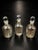A beautiful matching set of three vintage mercury-style glass apothecary bottles or decorative decanters, each retaining...