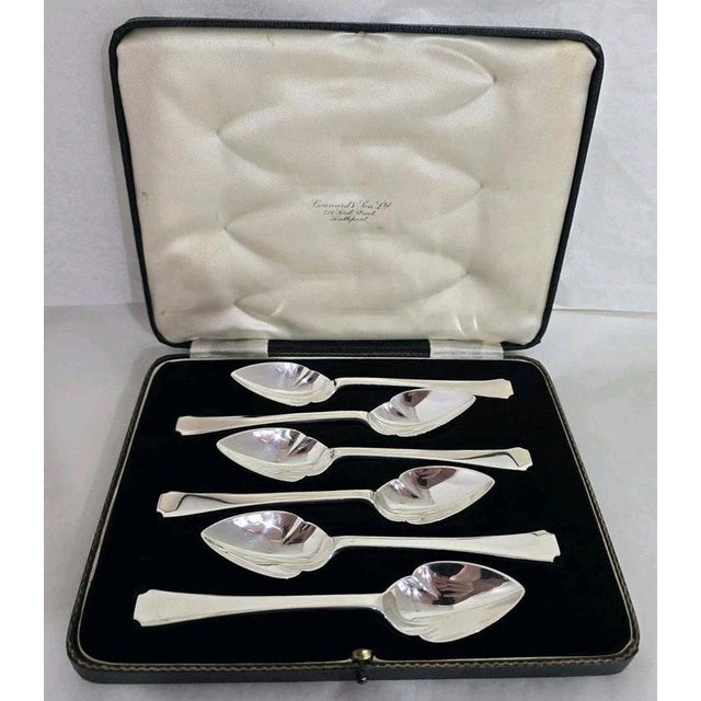 A fine set of six sterling silver dessert or fruit spoons dating to 1938, displaying a refined Art Deco design...