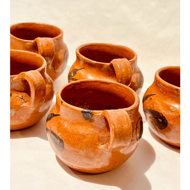These pots are lovely, would make great spice cellars, mugs or planters. There is a makers mark in the inside of the mugs,...