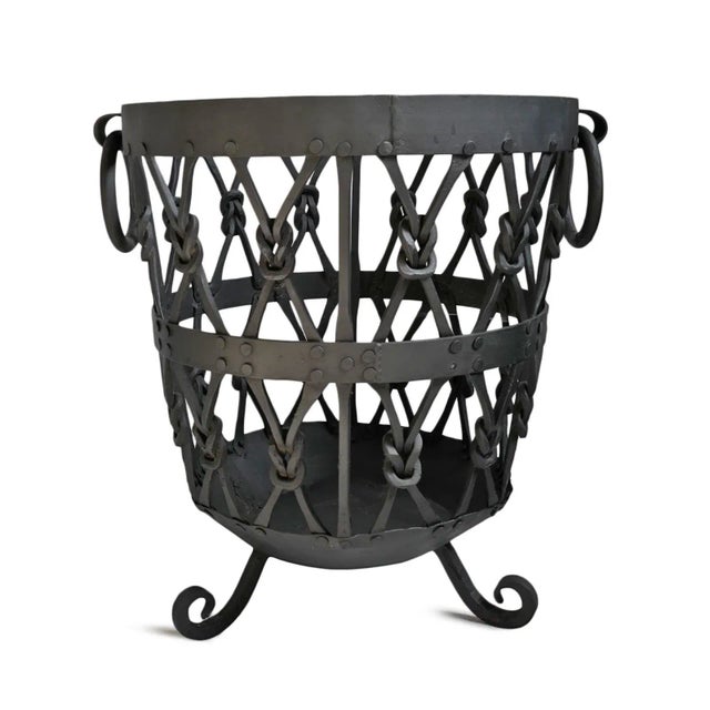Beautiful vintage knotted iron basket. Perfect for firewood or other storage. Great used indoors or out (iron will...