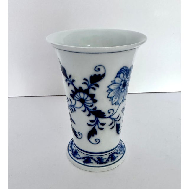 Meissen Blue Onion vase in trumpet shape, with blue decoration on white porcelain. Base of vase measures 2.7” diameter....