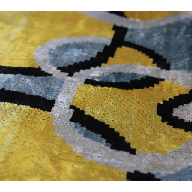 "A bold expression of modern artistry, this handmade velvet lumbar pillow features an abstract Ikat composition that...