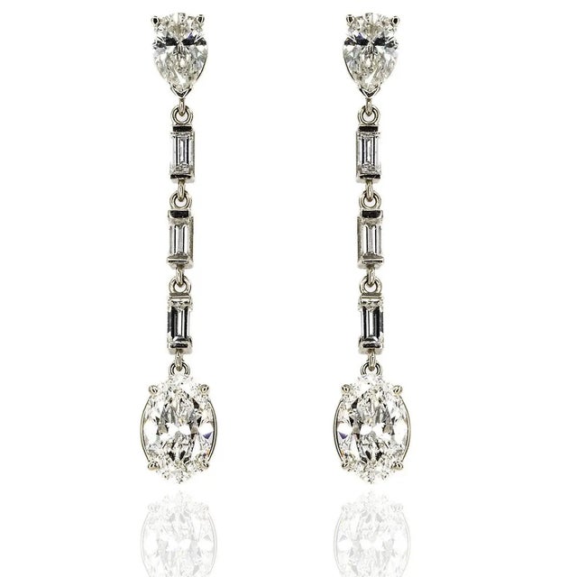 18k White gold earrings with 2 Oval Brilliant diamonds weighing 2.82 carats and 2 pear shape diamonds weighing 1.21 and 6...